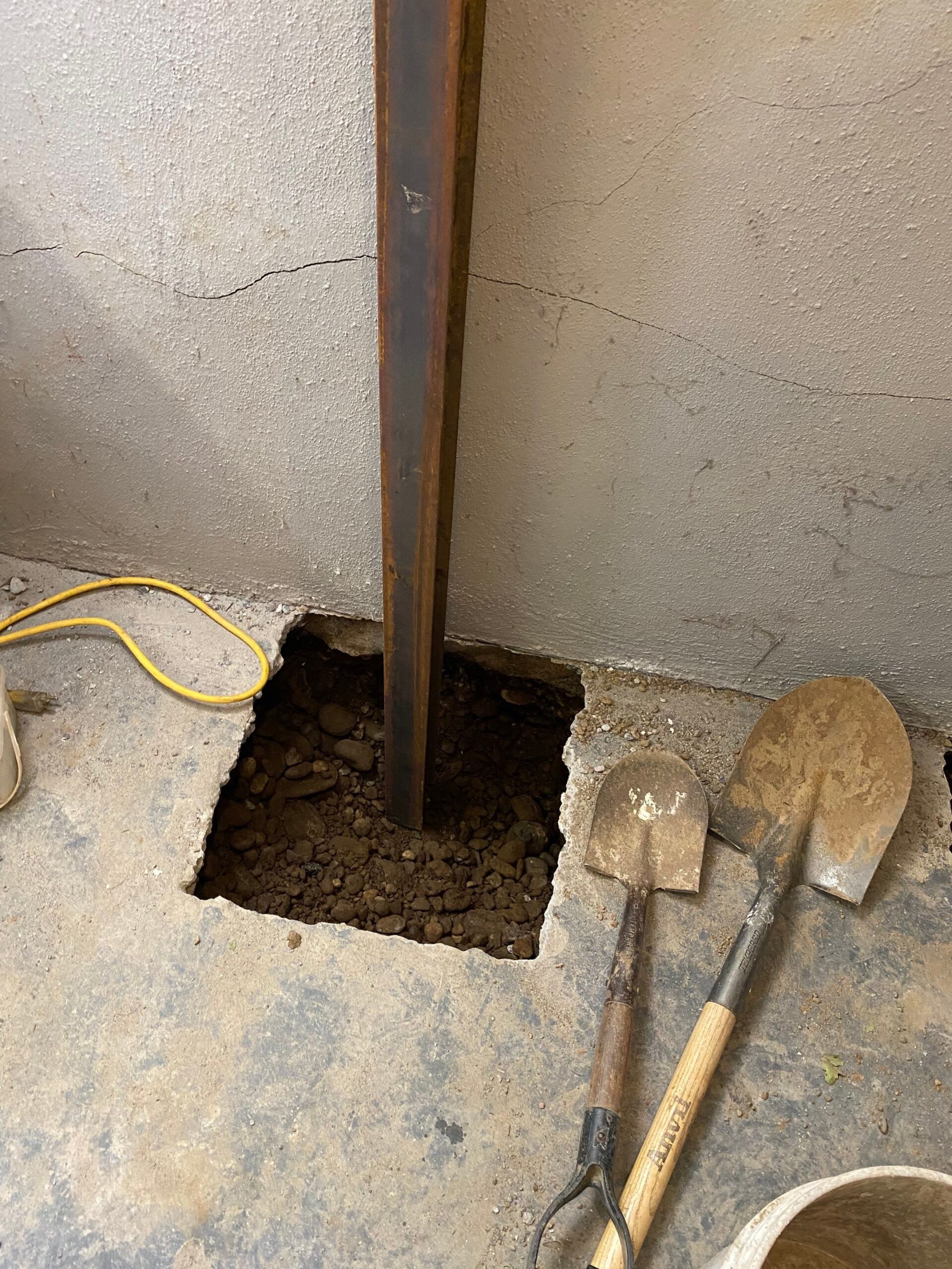 Old house foundation wall repair and renovate with installing metal sheets for waterproofing and protect from rain. Foundation repair